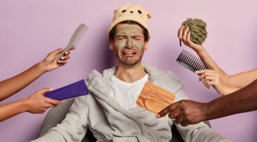 Man surrounded by grooming and skincare products